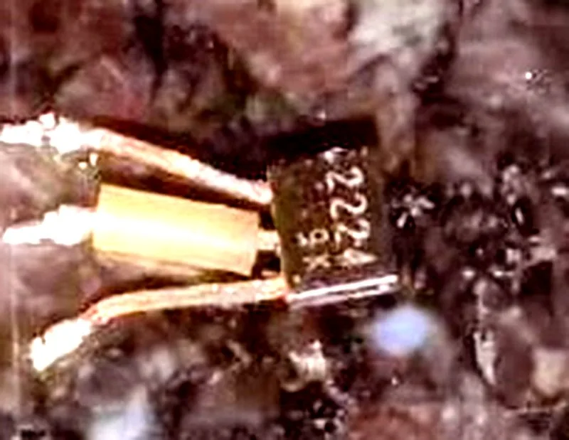 The removed transistor, three legs, marking 2224 visible on its face.